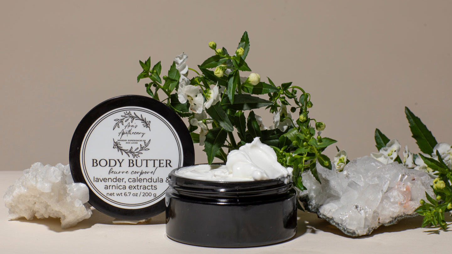 Body butter jar with a label, surrounded by decorative elements on a beige background
